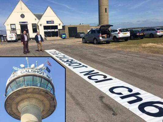 New banner for the tower is inspected and installed