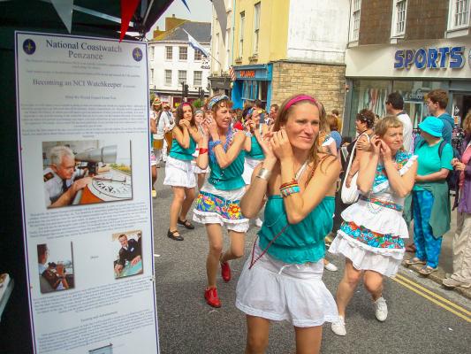 The Procession passes the NCI Display during the Golowan Festival