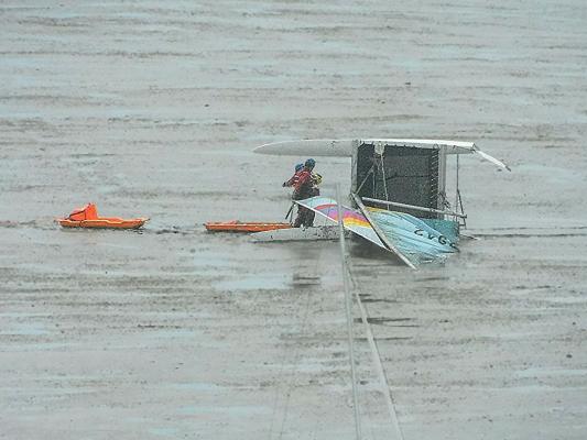 HM Coastguard mud rescue team attend a catamarn on the mud in Calshot lagoon