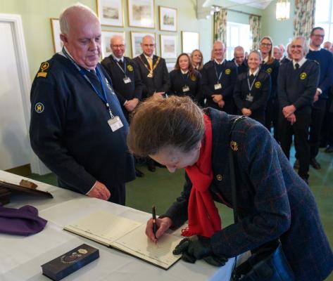 HRH signing the visitors book at Brancaster
