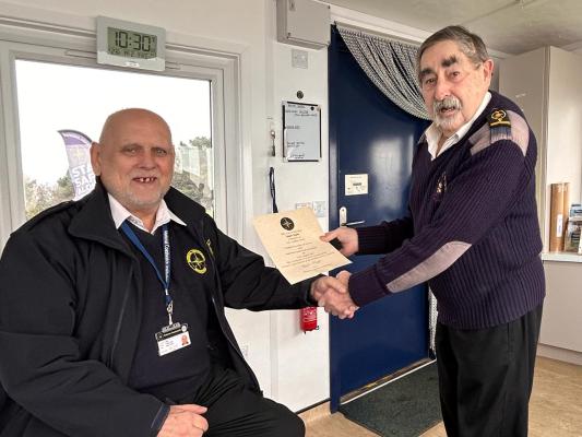 Station Manager Bryan Y presents Roger T with his 15 year Service Certificate