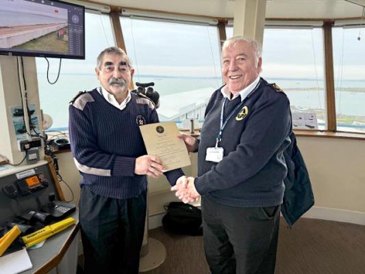 Malcolm C receives his 5 year Long Service Certificate from the Station Manager