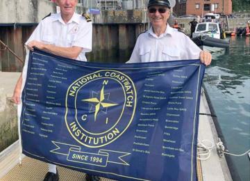 The flag is handed over to the NCI Stepper Point Station Manager